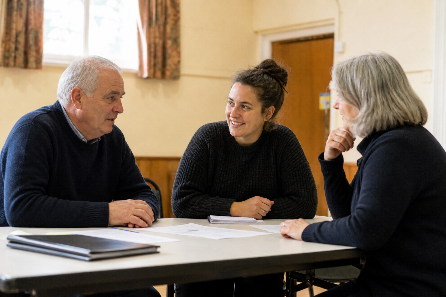 Community organisation team talking around a table